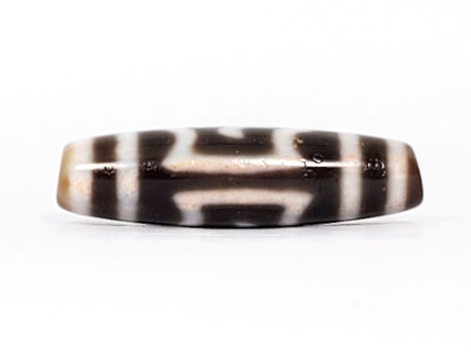 V-091424-GarudaBS Garuda dzi bead, alternate face, different motif composition, honey-tan ends visible, unretouched