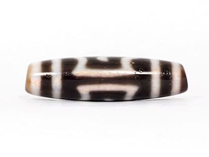 V-091424-GarudaBS Garuda dzi bead, alternate face, different motif composition, honey-tan ends visible, unretouched