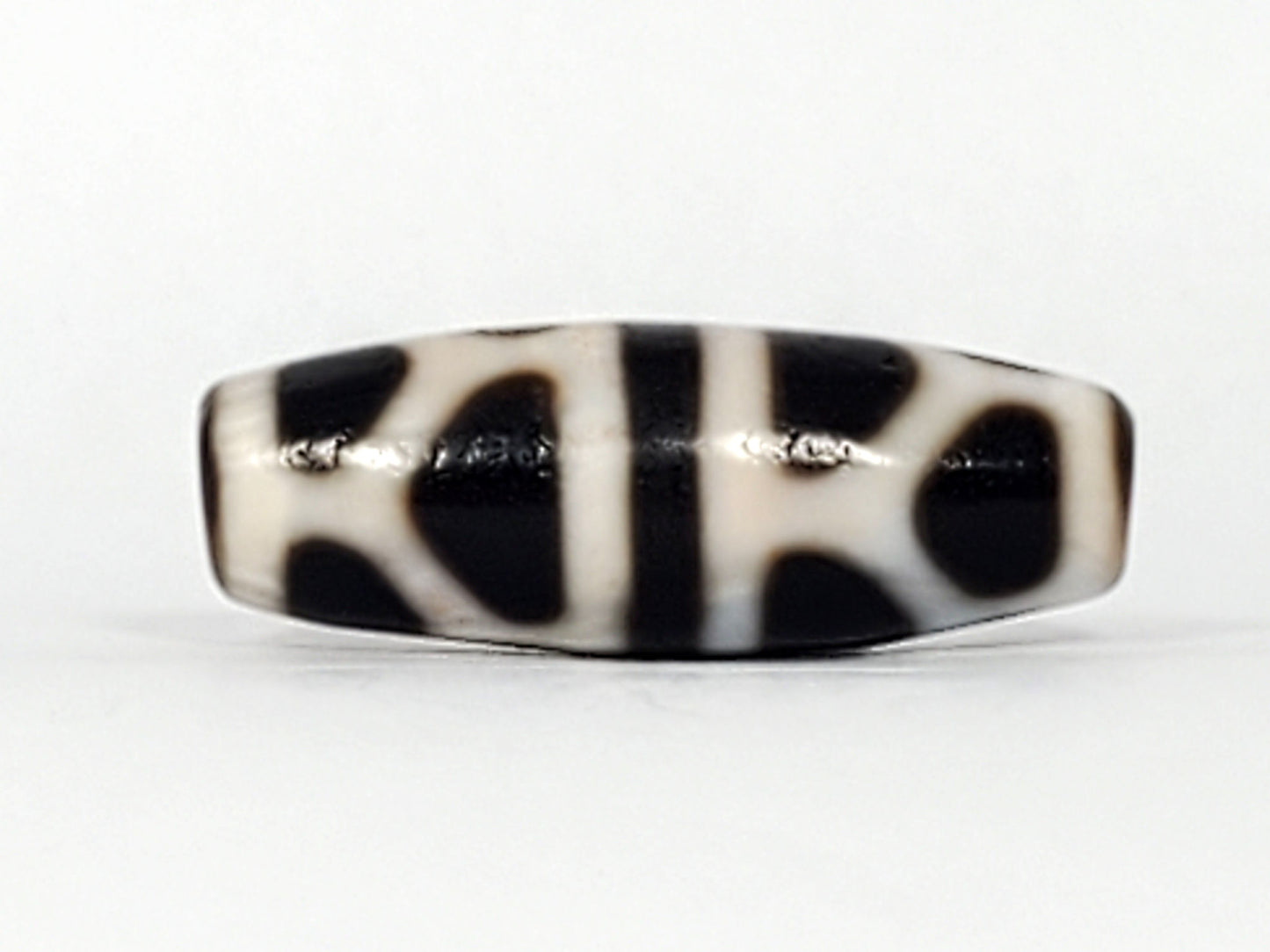 V-092824-DLBS Double Longevity dzi bead, third face angle, minor surface marks at central dividing band visible, unretouched