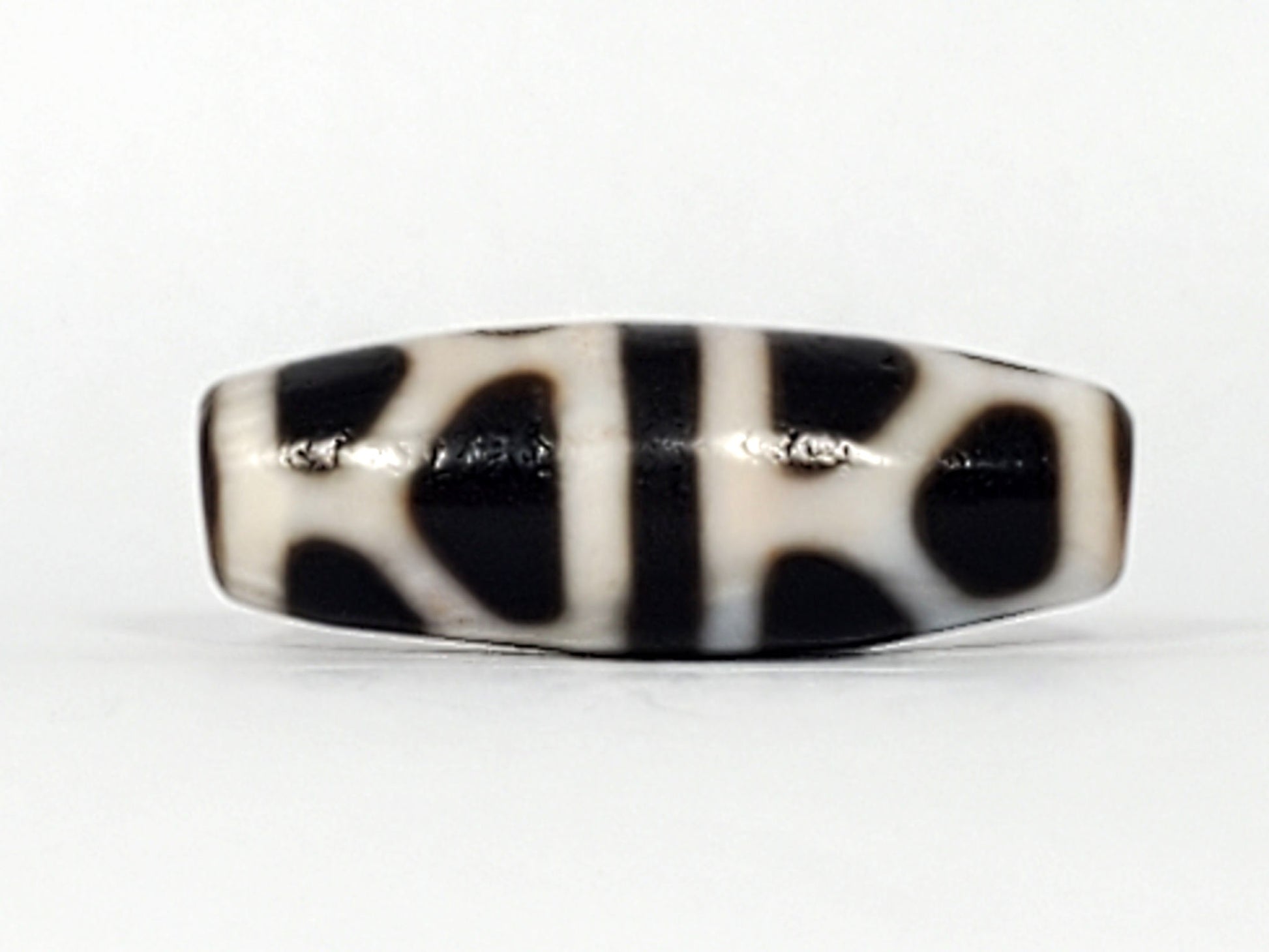 V-092824-DLBS Double Longevity dzi bead, third face angle, minor surface marks at central dividing band visible, unretouched
