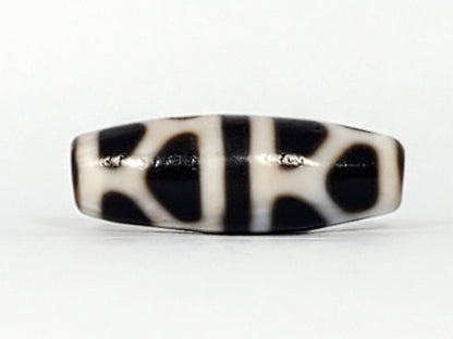 V-092824-DLBS Double Longevity dzi bead, third face angle, minor surface marks at central dividing band visible, unretouched