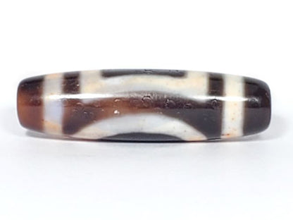 V-082123-HEBS Heaven & Earth dzi bead, fourth face angle, warm ivory cream zones against dark brown ground, unretouched