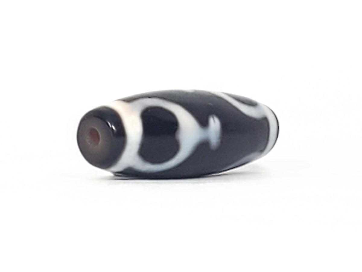 V-092224-TrVBS dzi bead, diagonal view showing drill hole, black agate, unretouched photo.