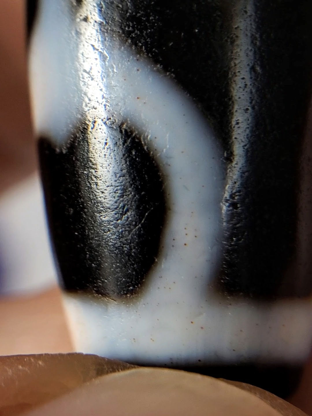 V-092224-TrVBS dzi bead, macro close-up of cinnabar inclusions within white motif line, unretouched.
Compliance Check
Item	Status
Trust badge x2 + photo line	✅
Unretouched disclosure at opening	✅
Opening hook unique	✅ (new; plain V- not exempt)
SEO title ≤67	✅ (64)
Meta ≤150	✅ (126)
Alt texts ≤125 each	✅
Product ID in title/slug/alt	✅ V-092224-TrVBS
Spec block bold labels	✅
Bloodspot tier justified	✅ Tier 3, macro-documented, full section
-BS suffix placement	✅ suffix, not prefix
Collection links (from live