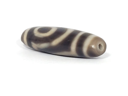 Ac-071026-TWE3 ancient two eye dzi angled view drill end B charcoal grey-brown end cap unretouched
