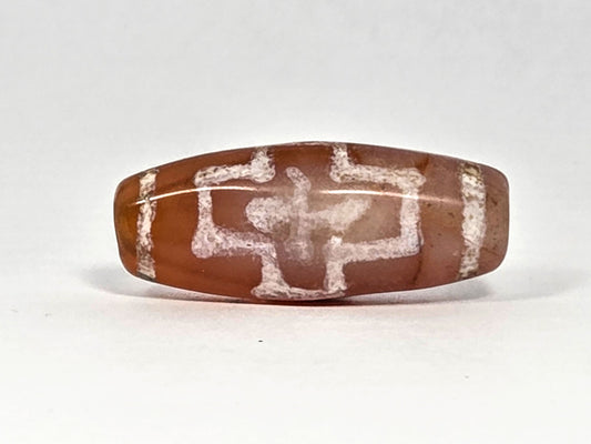 Ac-080426-DCCS ancient carnelian dzi bead 29.1×12.2mm, Face C view showing eroded stepped nested cross geometry, unretouched