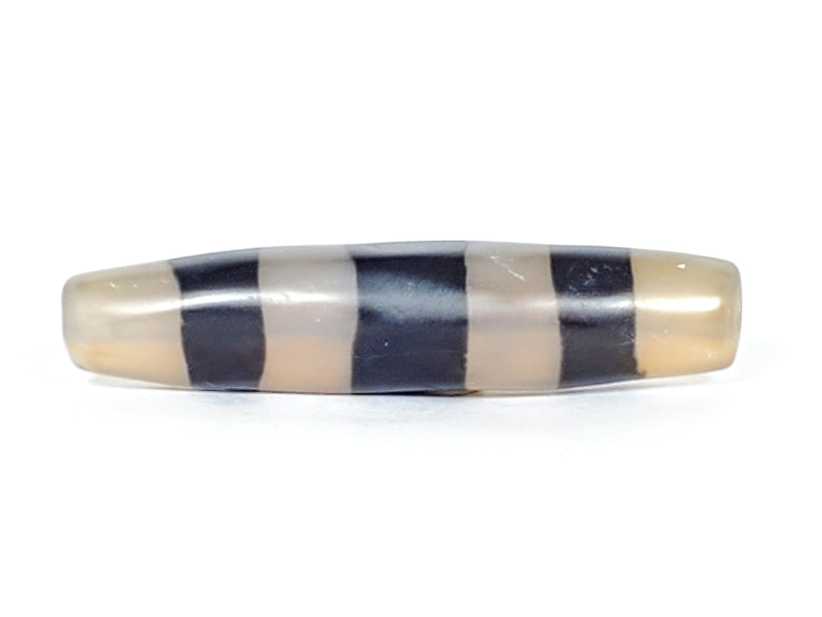 Ac-061426-5SChung ancient Cho dzi, 57.5×13.1mm, Face A, milky translucent grey-white ground, pitch-black bands, unretouched