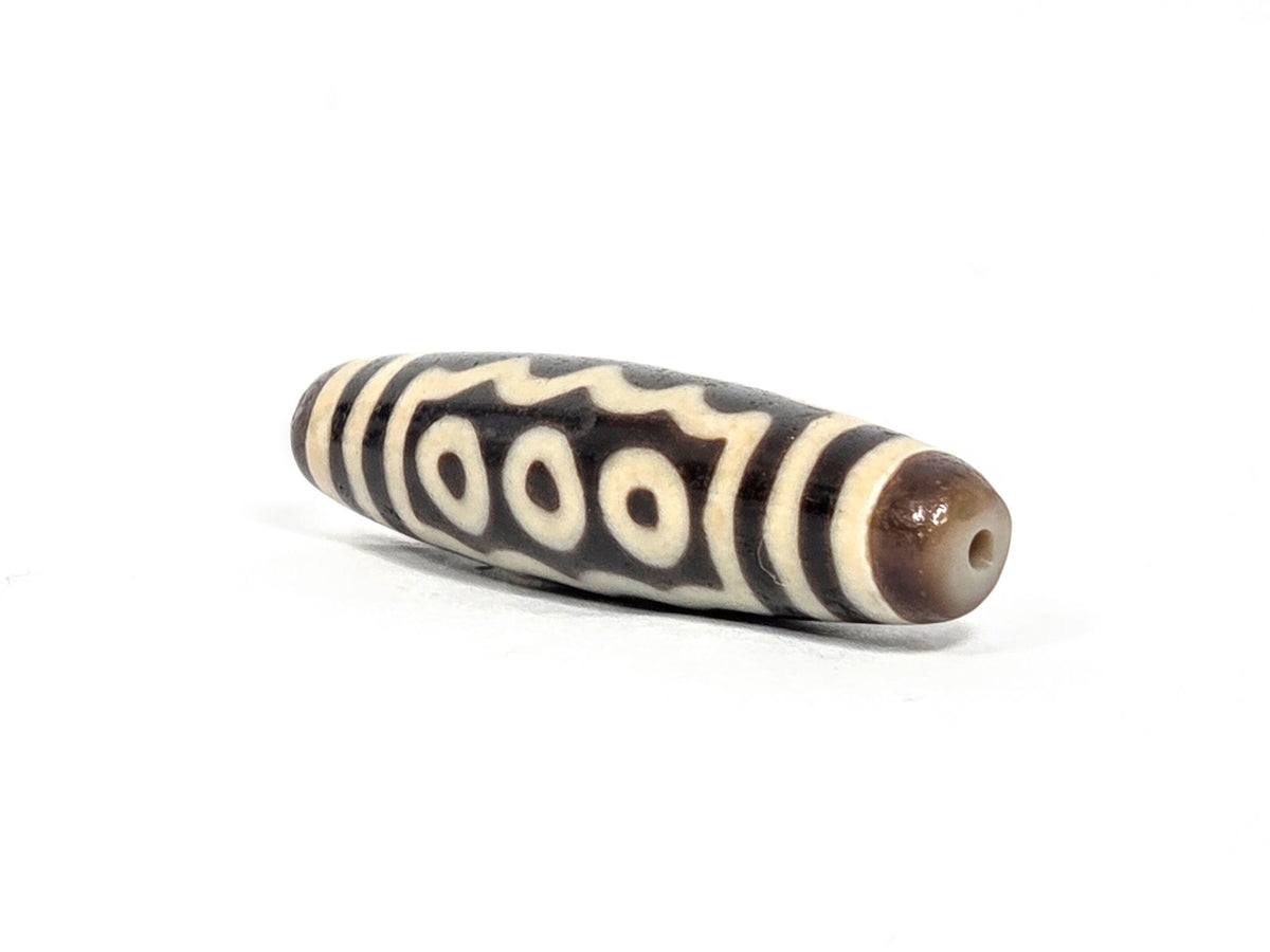 Ac-071026-7E ancient seven eye dzi angled view drill end B four-eye face visible unretouched