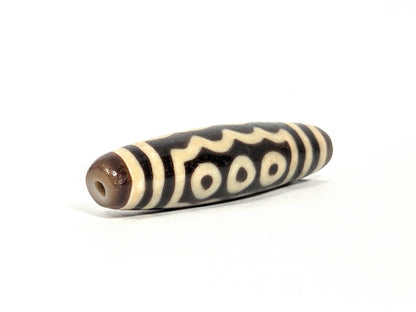 Ac-071026-7E ancient seven eye dzi angled view drill end A warm brown end cap small clean hole unretouched