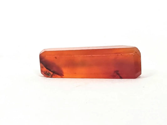 Ancient Indus Valley carnelian bead, translucent orange-red, beveled rectangular form, natural inclusions, polished surface, 28mm