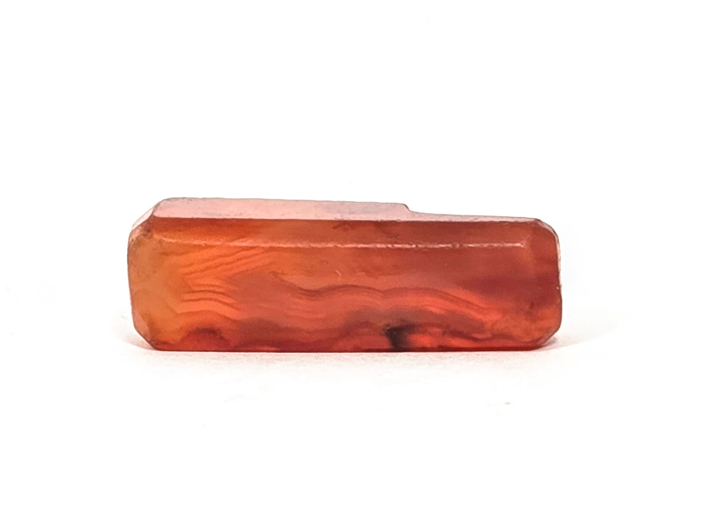 Anc-0626-CBev2, Face B, natural banding visible through translucent orange-red carnelian, beveled form, unretouched
