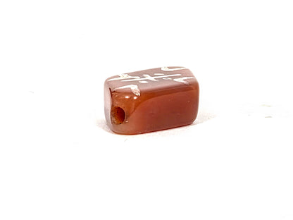 Opposite end view of ancient etched carnelian bead AC-101026-CM3 showing second drill hole and warm amber carnelian body, no cracks, high-gloss ancient polish