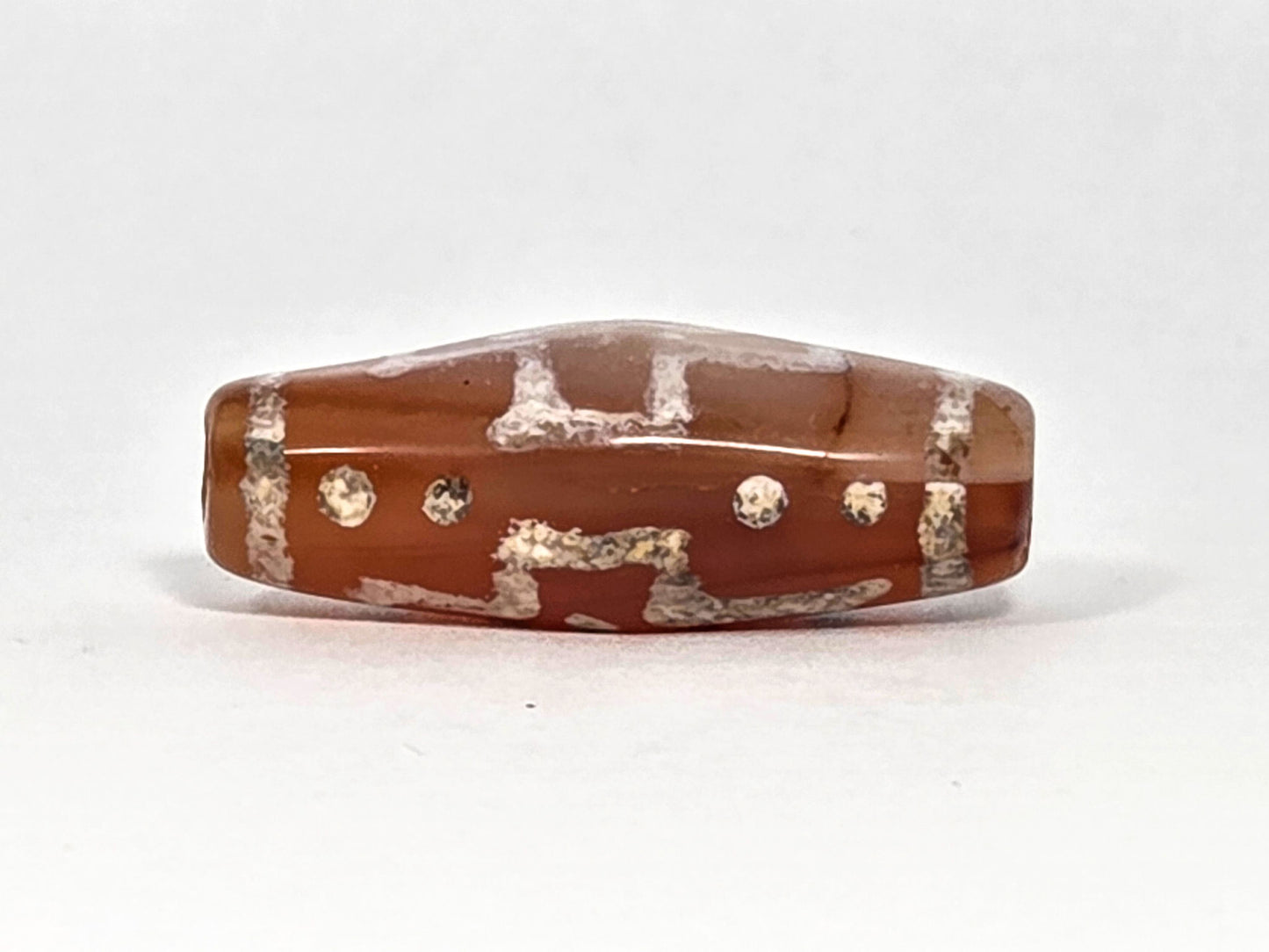 Ac-080426-DCCS ancient carnelian dzi bead 29.1×12.2mm, Face B showing partial cross motif and star dots lower register, unretouched