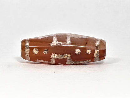 Ac-080426-DCCS ancient carnelian dzi bead 29.1×12.2mm, Face B showing partial cross motif and star dots lower register, unretouched