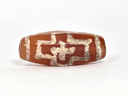 Ac-080426-DCCS ancient carnelian dzi bead 29.1×12.2mm, Face C view showing eroded stepped nested cross geometry, unretouched
