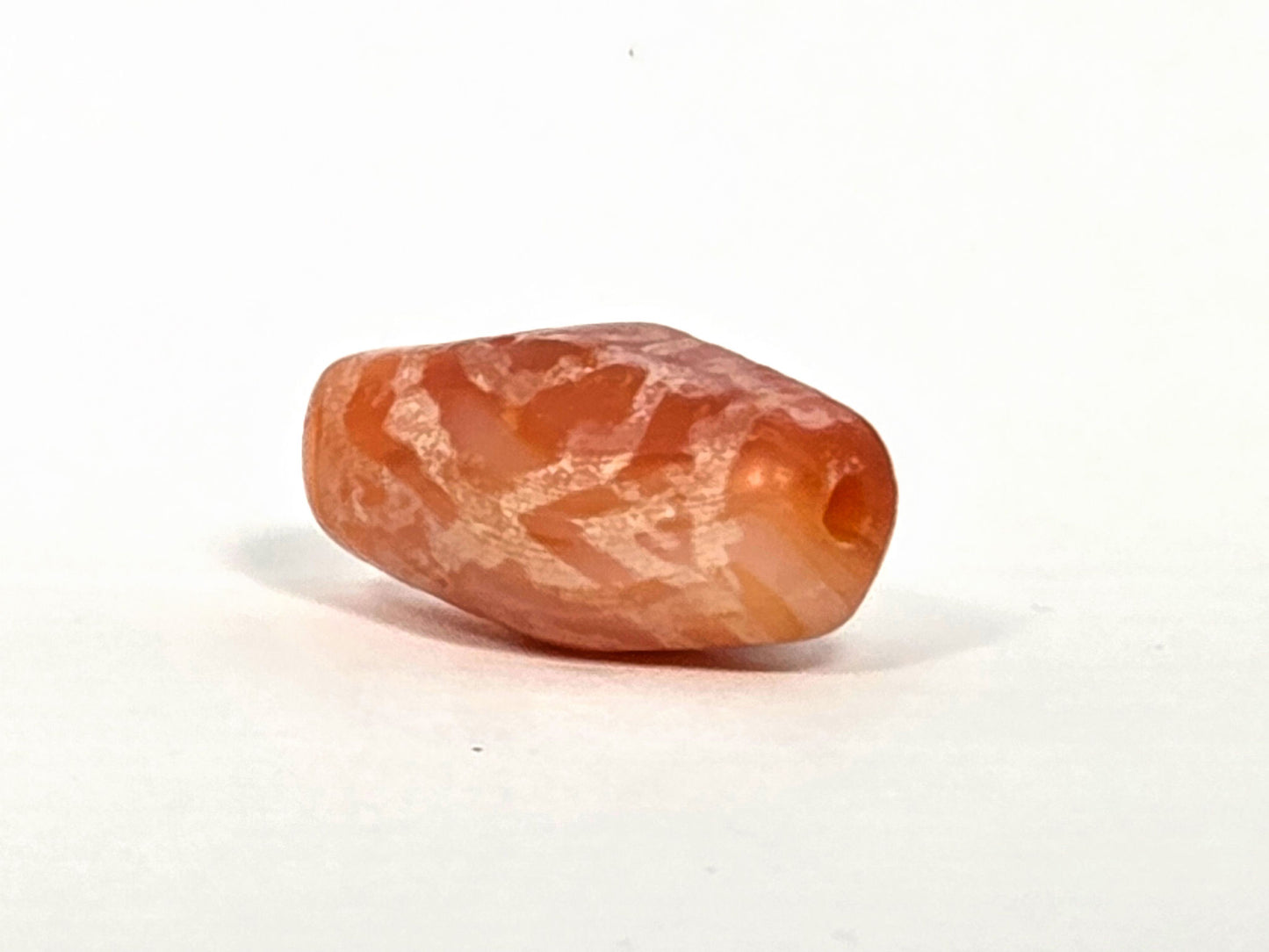Ac-083126-2EHGTT ancient carnelian dzi drill end view one asymmetric taper orange carnelian unretouched