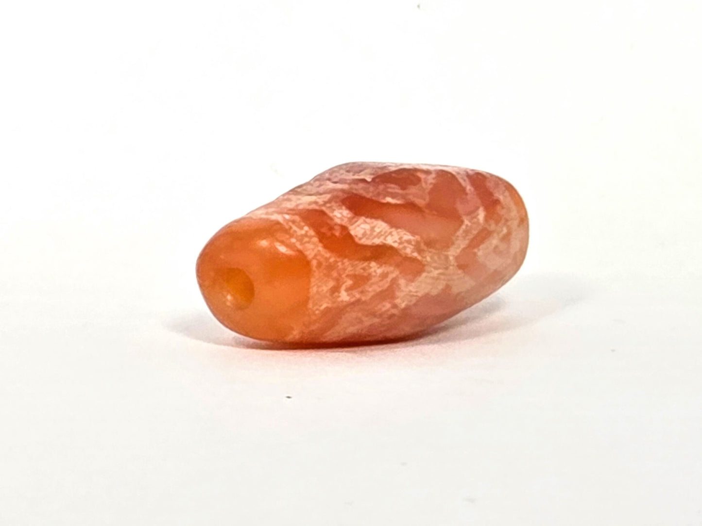 Ac-083126-2EHGTT ancient carnelian dzi drill end view two warm orange carnelian tip unretouched