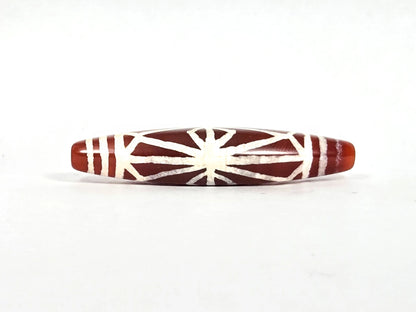 Second lateral profile of ancient carnelian starburst bead showing reverse face with radiating lines, diamond lozenge frame, and horizontal end-cap band lines, 49.6 mm × 10.7 mm