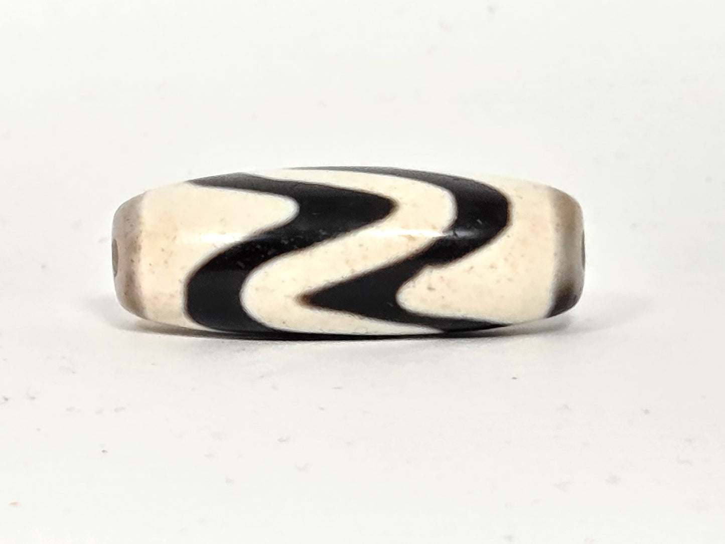 Ancient Tibetan Double Wave Dzi bead, 500–700 years old — Side B showing Z-curve double wave motif, natural agate with authentic surface patina — unretouched photo — Ancient Dzi Shop