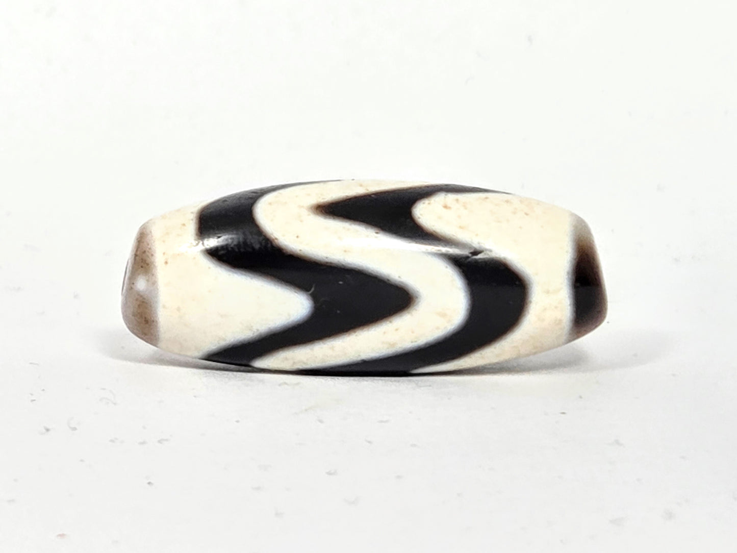 Ancient Tibetan Double Wave Dzi Bead with Extreme Bloodspots | 500–700 Years Old