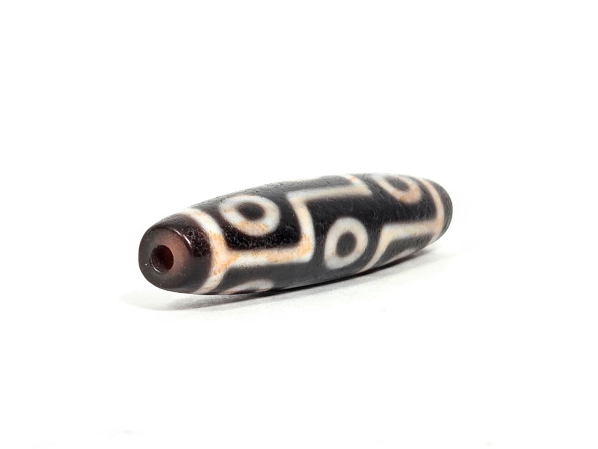 At-071426-9EBS2 end angle A — warm reddish-brown end cap, clean drill opening, motif wrap visible, unretouched.