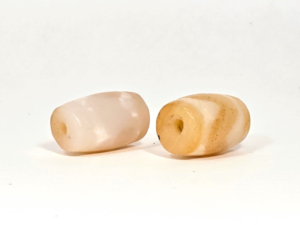 At-073026-WPair antique wave dzi pair face view pale peach-cream left honey ochre right unretouched