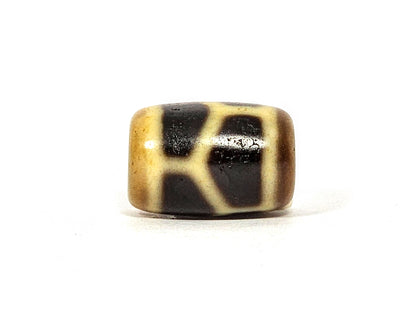 Antique longevity motif dzi bead, cream and dark brown agate patterning, barrel-shaped, polished surface with natural patina
