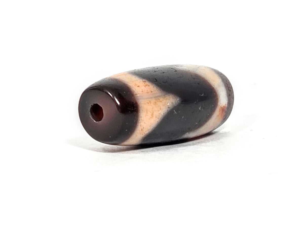 At-071426-TaBS4 end angle A — deep warm reddish-brown end cap, small clean drill opening, unretouched.