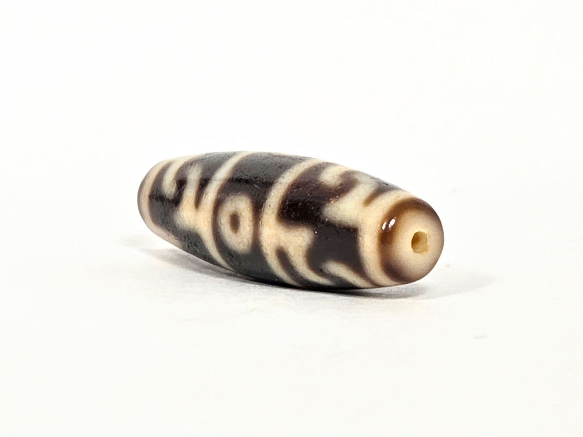 At-071426-3EGRP Three Eye Guru Rinpoche Paraphernalia end angle B — opposite cream end cap, body visible, unretouched.