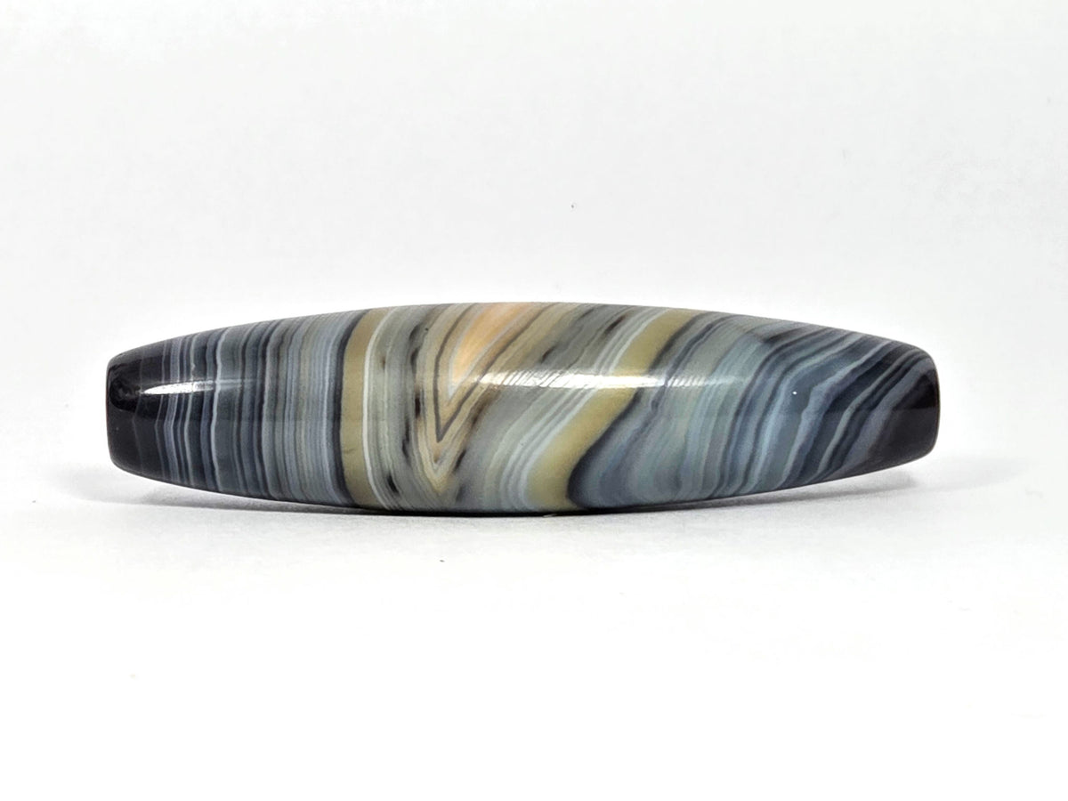 Naturally-formed one eye dzi bead, blue-grey and gold banded agate with striped patterns, polished surface