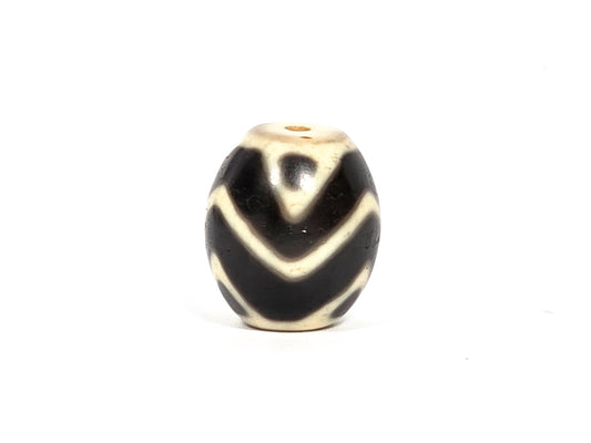At-080926-WTT antique round Wave Tiger Tooth dzi bead 17.8×15.6mm, rotation C showing tiger tooth upper zone, broader arc chevrons, and age surface texture in cream zones, unretouched