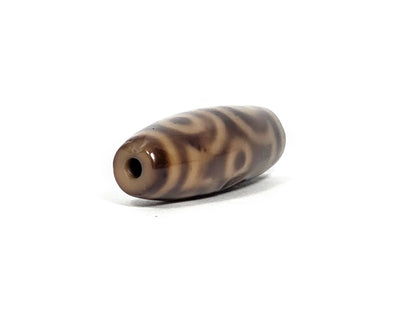 At-082326-6EMD antique six eye dzi bead drill end view two warm dark brown agate unretouched