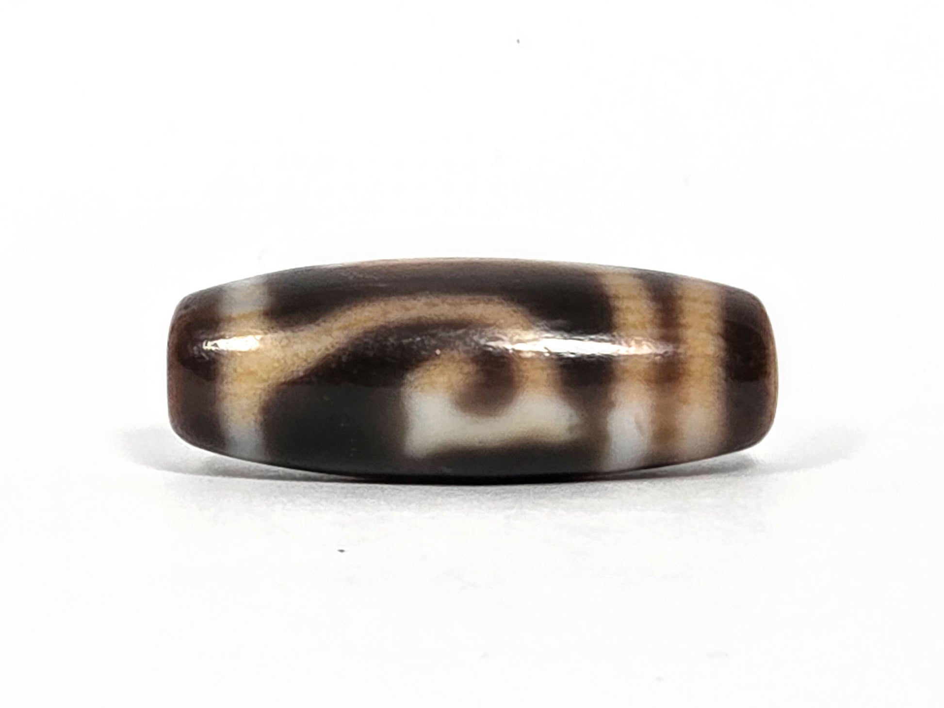 At-082326-GTBS antique Green Tara dzi bead 30.3×11.3mm, Face B showing wave continuation of Tara scroll on dark brown ground, stripe borders, unretouched