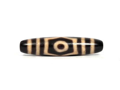 Three Eye Dzi Bead, black agate with cream striping and central eye motif, polished surface, 50.7mm length