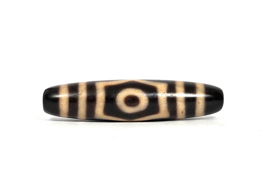 Three Eye Dzi Bead, black agate with cream striping and central eye motif, polished surface, 50.7mm length