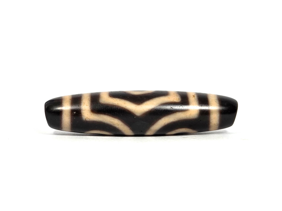Three Eye Motif black agate dzi bead with cream striped pattern and polished surface