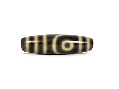 Second face of antique Tibetan two eye dzi bead AT-102126-2E — second cream eye framed by a curved line, positioned toward the opposite end from the first eye, on dark brown agate, 41.5 mm × 11.7 mm