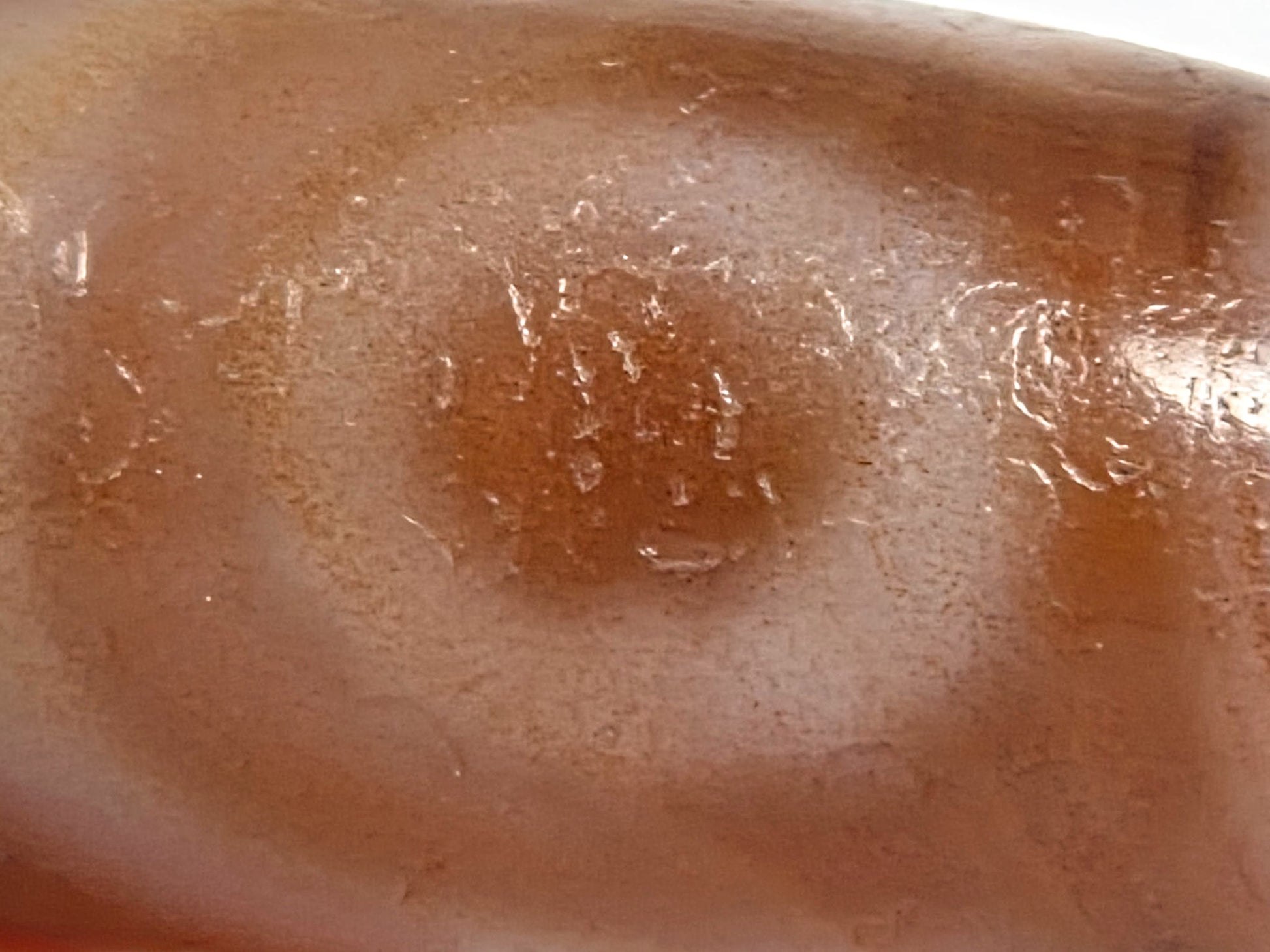 At-080426-2EBS macro eye-zone showing compound bloodspot concentration within and around eye ring, age-crystalline surface texture visible, unretouched