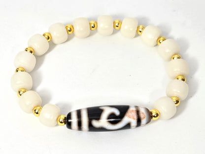 Overhead view of antique Green Tara Dzi bracelet with 14 white bodhi root beads and gold-tone spacers — antique Tibetan dzi focal piece, 200+ years old — unretouched photo — Ancient Dzi Shop