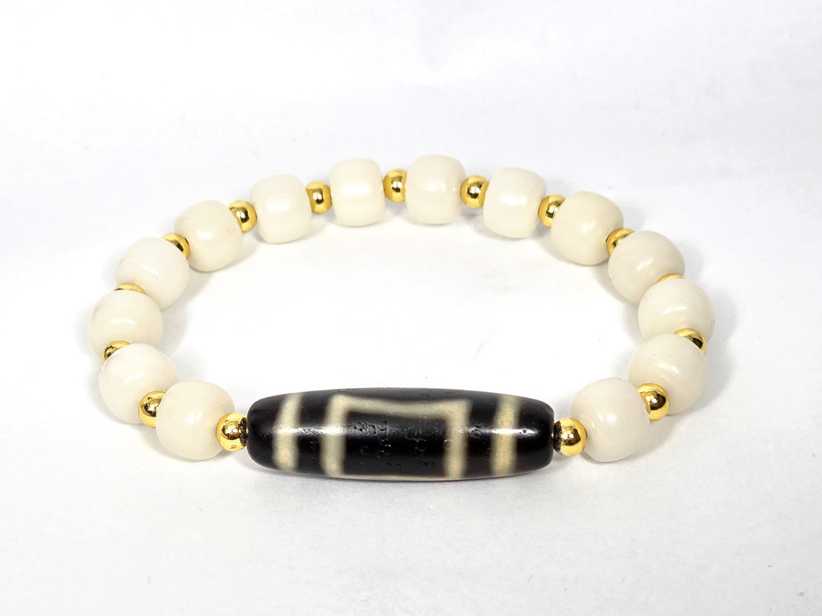 Heaven & Earth dzi bracelet with black striped agate barrel bead and white bodhi root beads with gold spacers