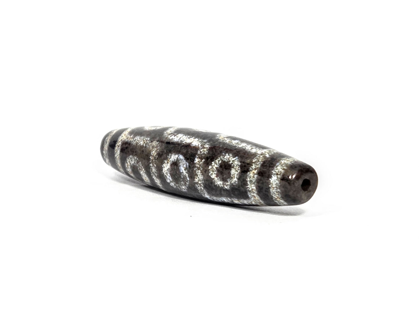 N-082326-9EBS new nine eye dzi bead drill end view one very dark brown-black tip agate unretouched