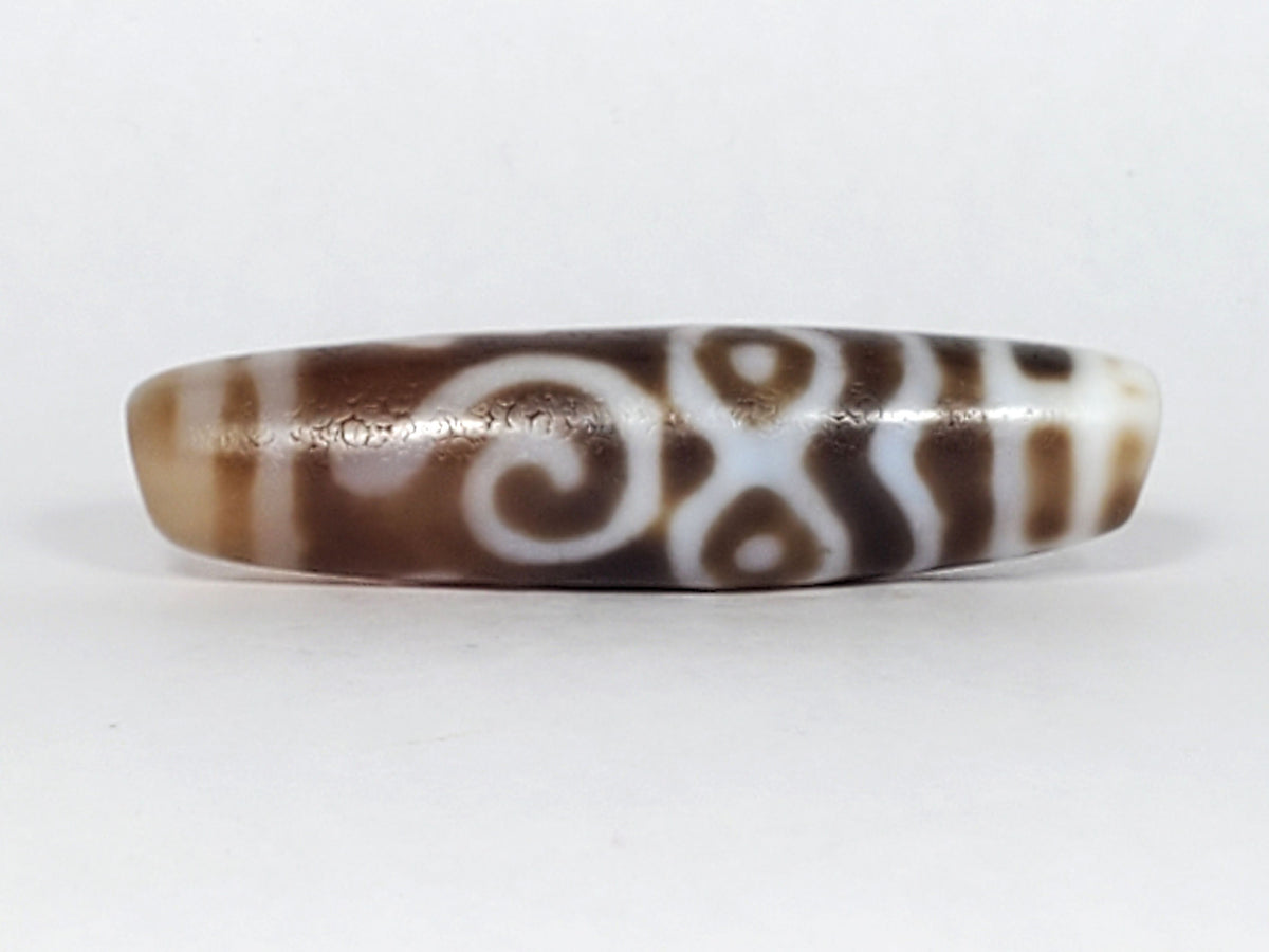 At-061926-PDEBS Face B, double-spiral scroll composition, warm brown chalcedony ground, unretouched