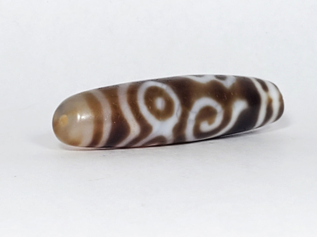At-061926-PDEBS angled tip A, honey-tan end cap, scroll motif wrap, high-gloss surface, unretouched