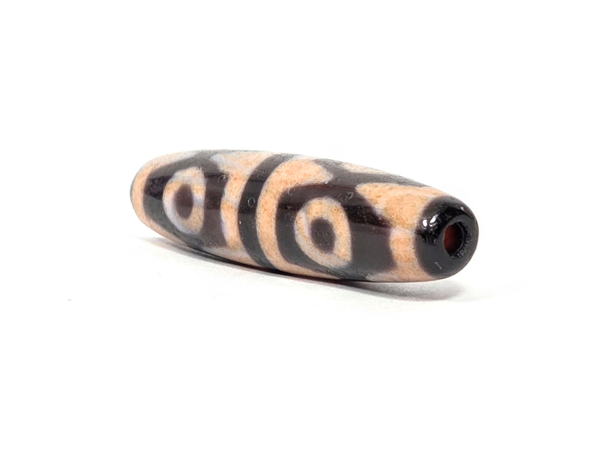 V-061026-6ETTBS opposite end, drill hole, tiger tooth motif on body, cinnabar-peach field visible, unretouched