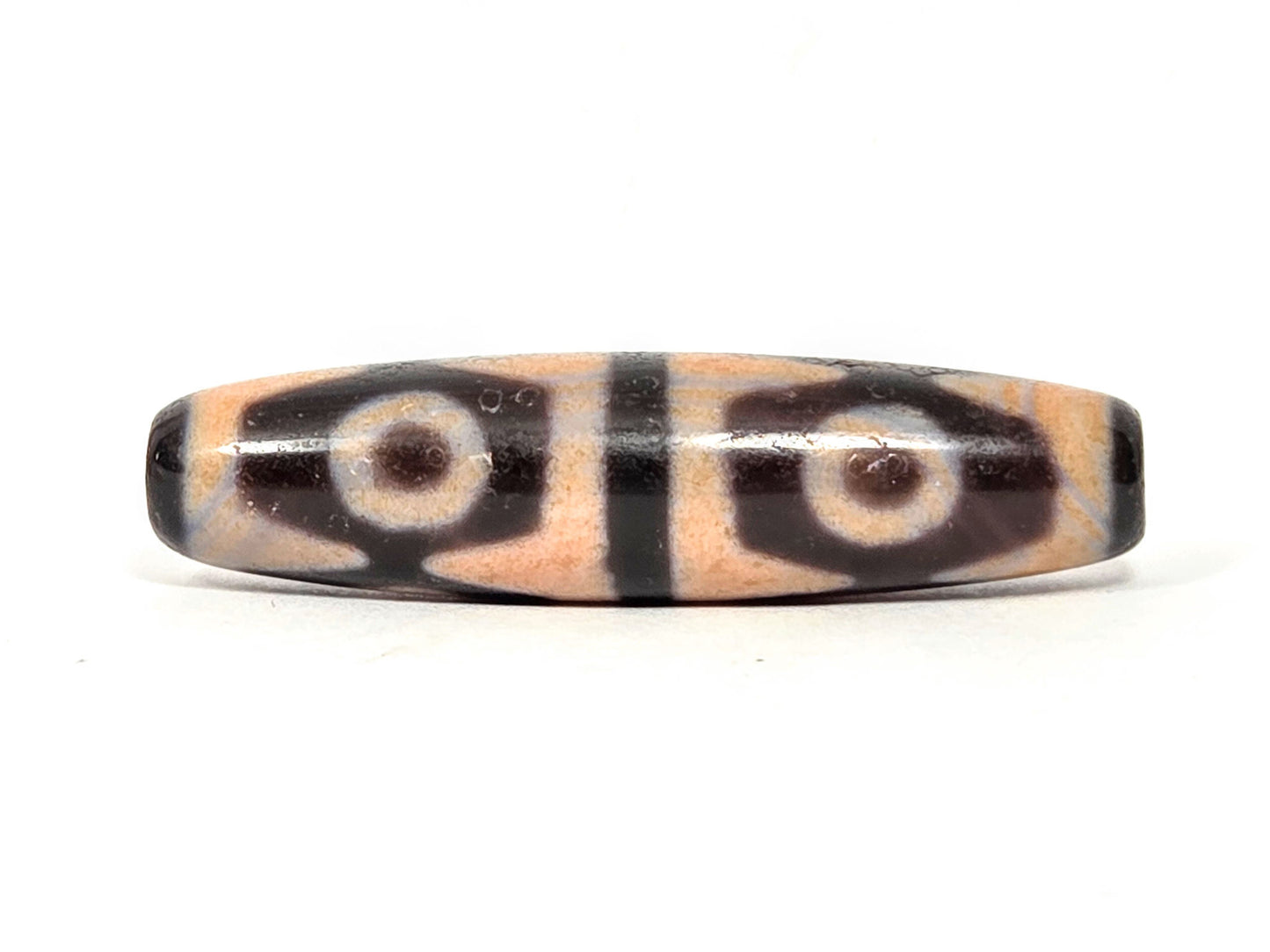 V-061026-6ETTBS face A, 49.1×12.3mm, cinnabar sandy-peach field, 2 eyes tiger tooth, dark end caps, unretouched