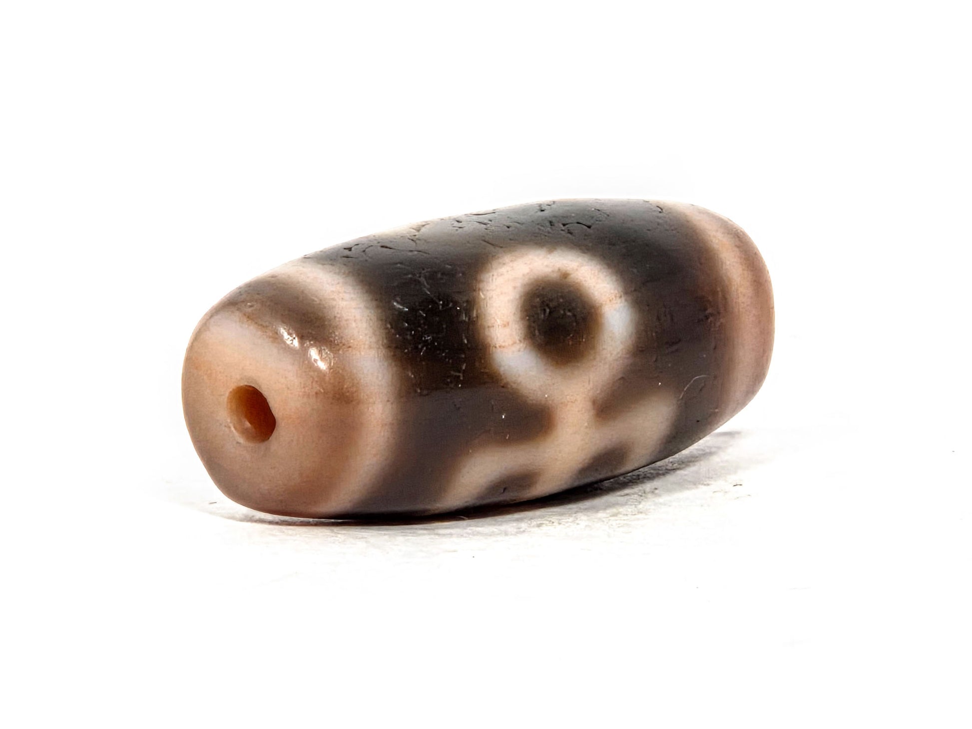V-071426-BNF end angle B — opposite warm end cap, eye and descending motif elements visible, unretouched.