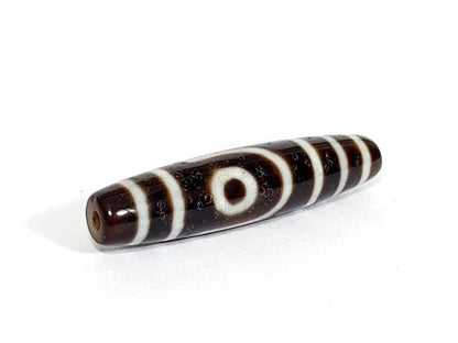 A vintage Dzi bead with a captivating Two Eye Motif. This authentic artifact showcases the timeless beauty and cultural significance of ancient Dzi bead
