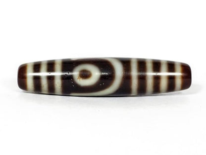 A vintage Dzi bead featuring a unique Two Eye Motif and a rare Triple Bar design. This rare find showcases the intricate craftsmanship and symbolic beauty of ancient Dzi beads