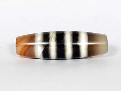 Vintage Seven Stripe Chung Dzi Bead" Description: "Authentic vintage Seven Stripe Chung Dzi bead showcasing its distinctive seven stripe pattern. This ancient bead carries a sense of history and cultural significance