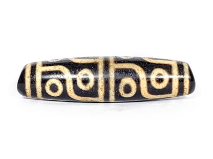 A vintage Dzi bead featuring a captivating Twelve Eye Motif. This authentic artifact embodies the rich history and symbolic significance of ancient Dzi beads